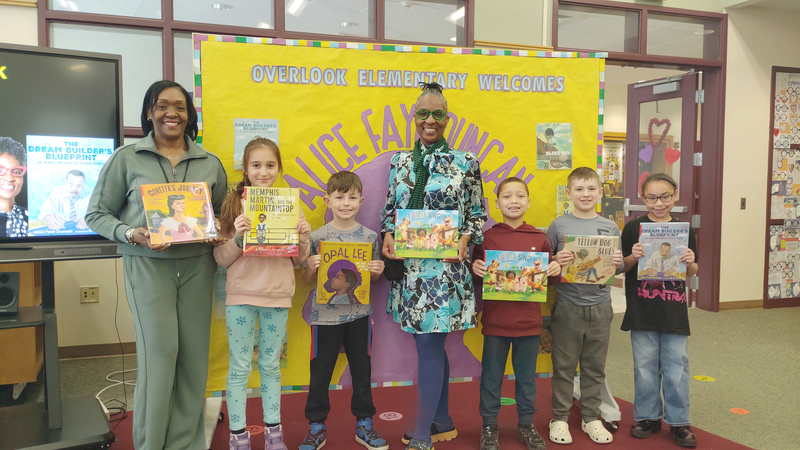 Ms. Boyd and Overlook students pose with Ms. Duncan and her books