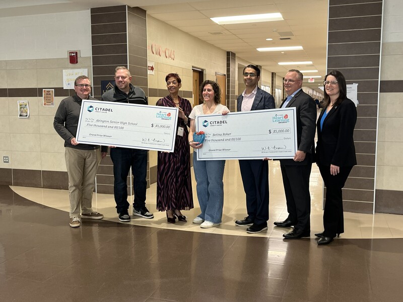 Ms. Roher surprised during class with her grand prize giant check