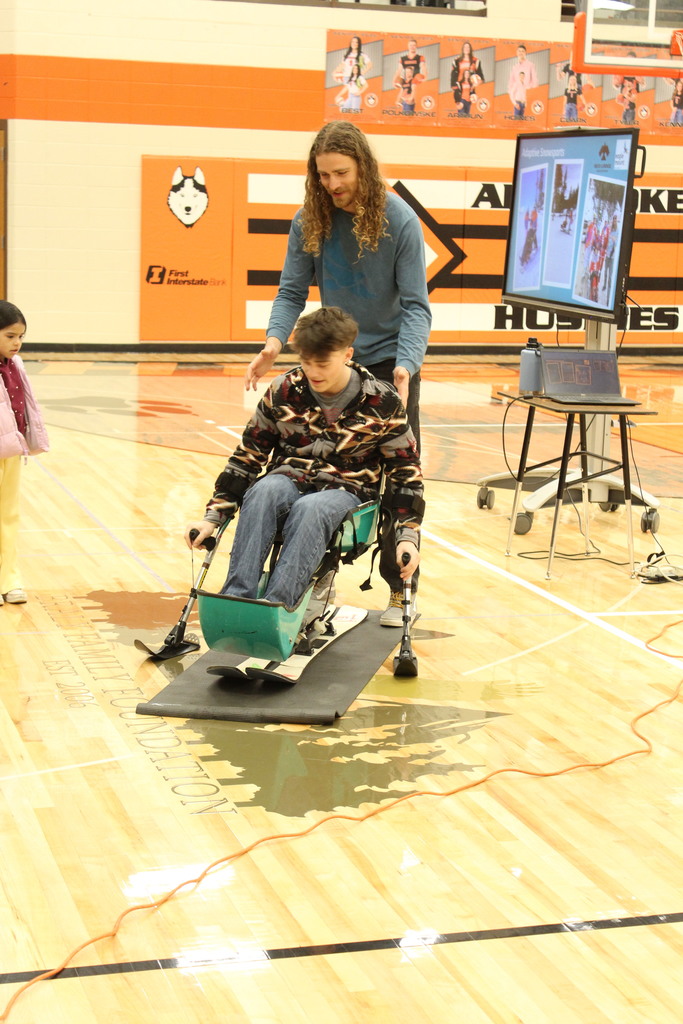 student sitting in sit ski