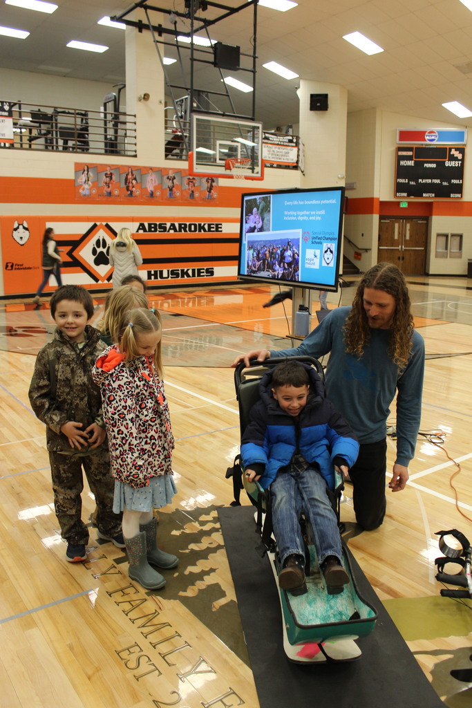 student sitting in sit ski
