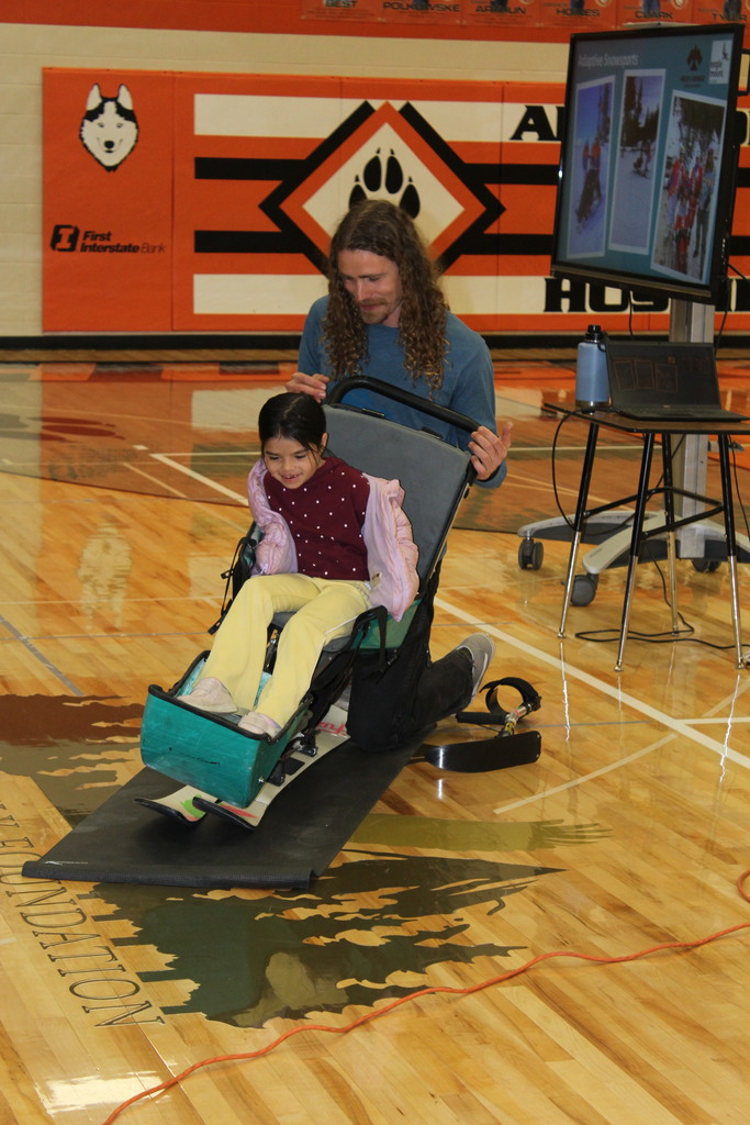 student sitting in sit ski