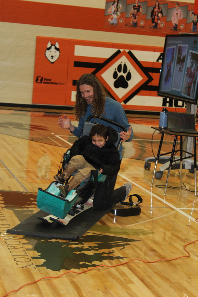 student sitting in sit ski