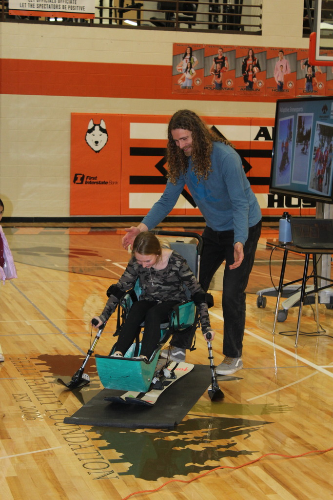 student sitting in sit ski