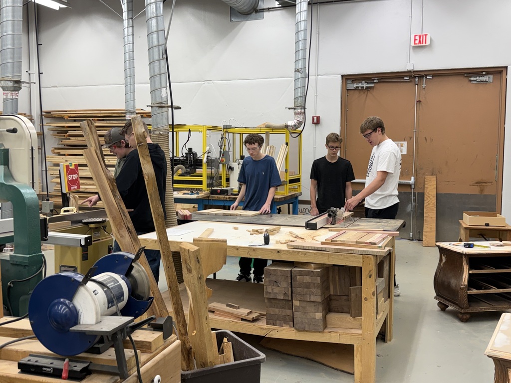 Five student making charcuterie boards.