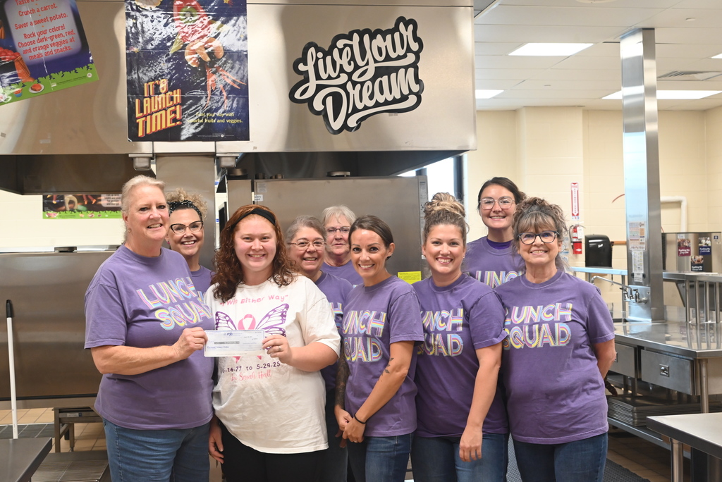 Lunch staff accepting donation from family