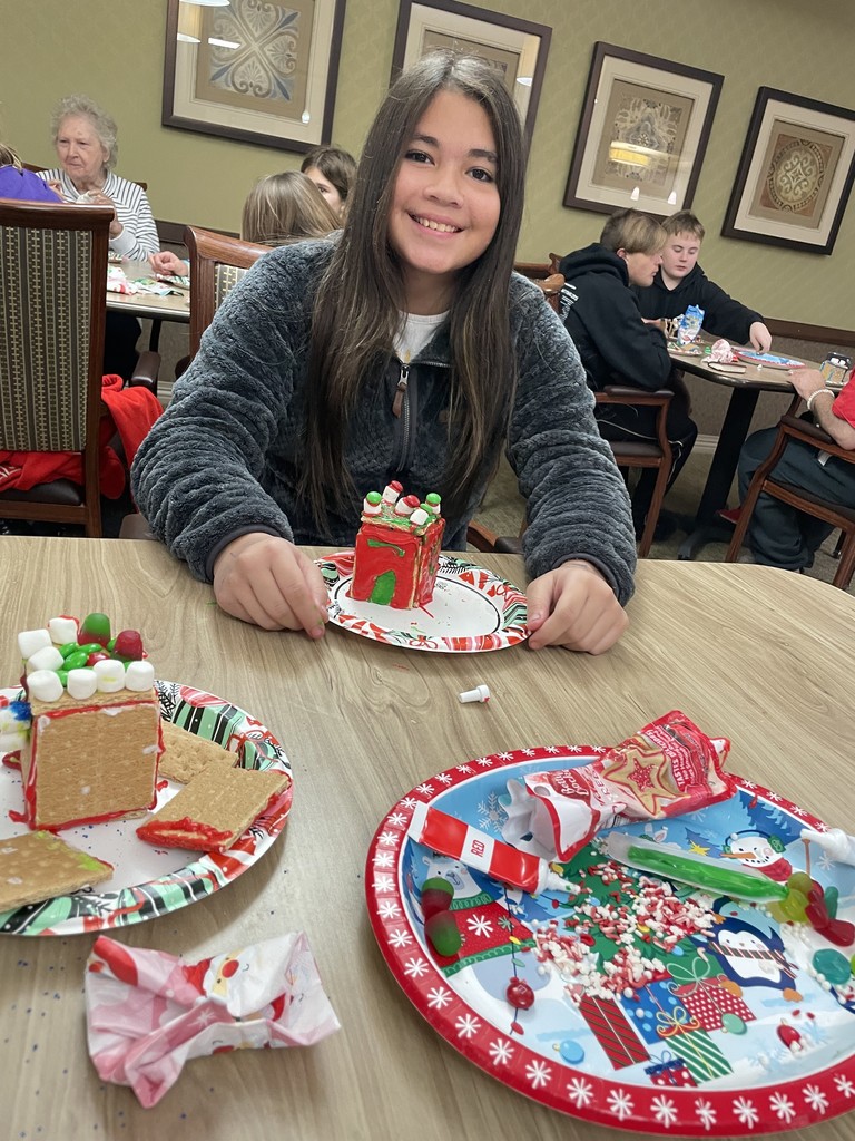 Students and Vancrest residents making gingerbread houses
