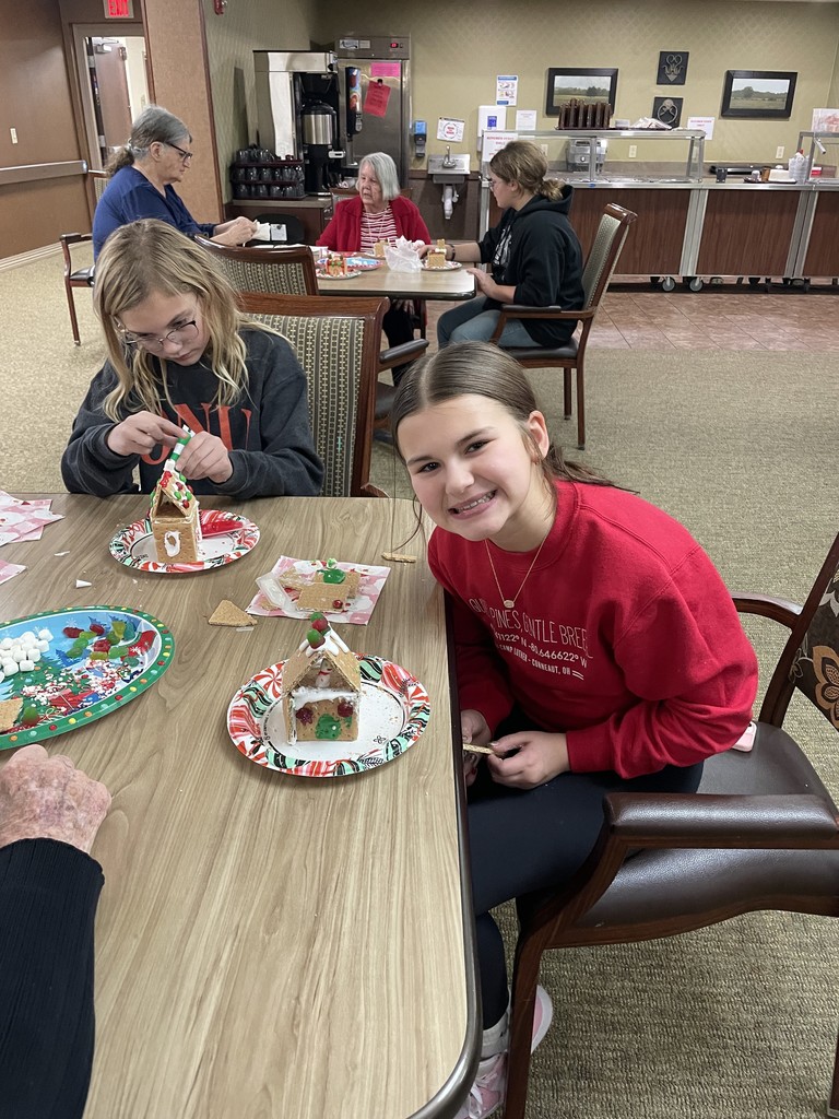 Students and Vancrest residents making gingerbread houses