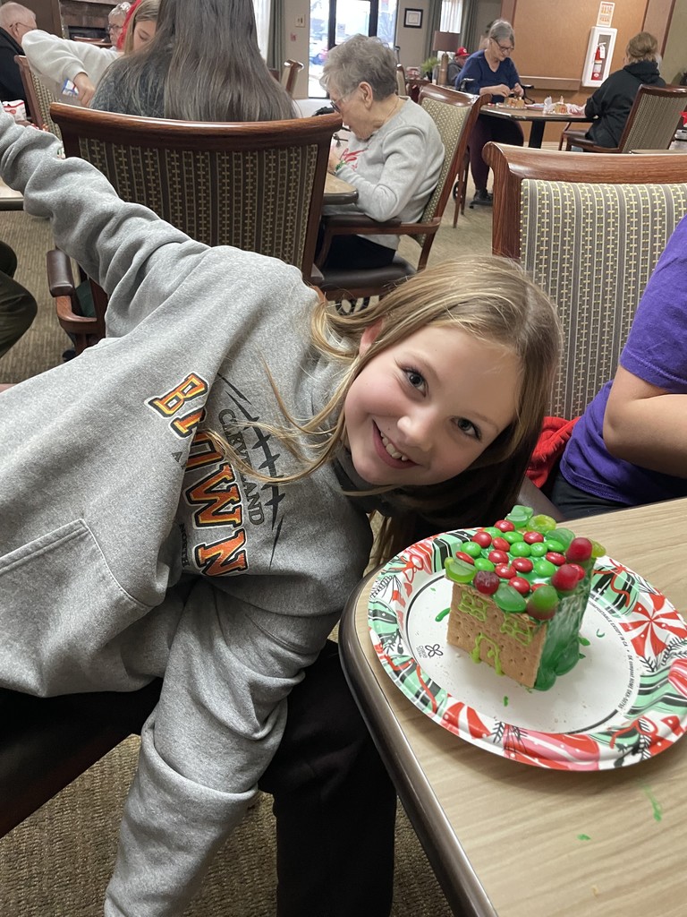 Students and Vancrest residents making gingerbread houses