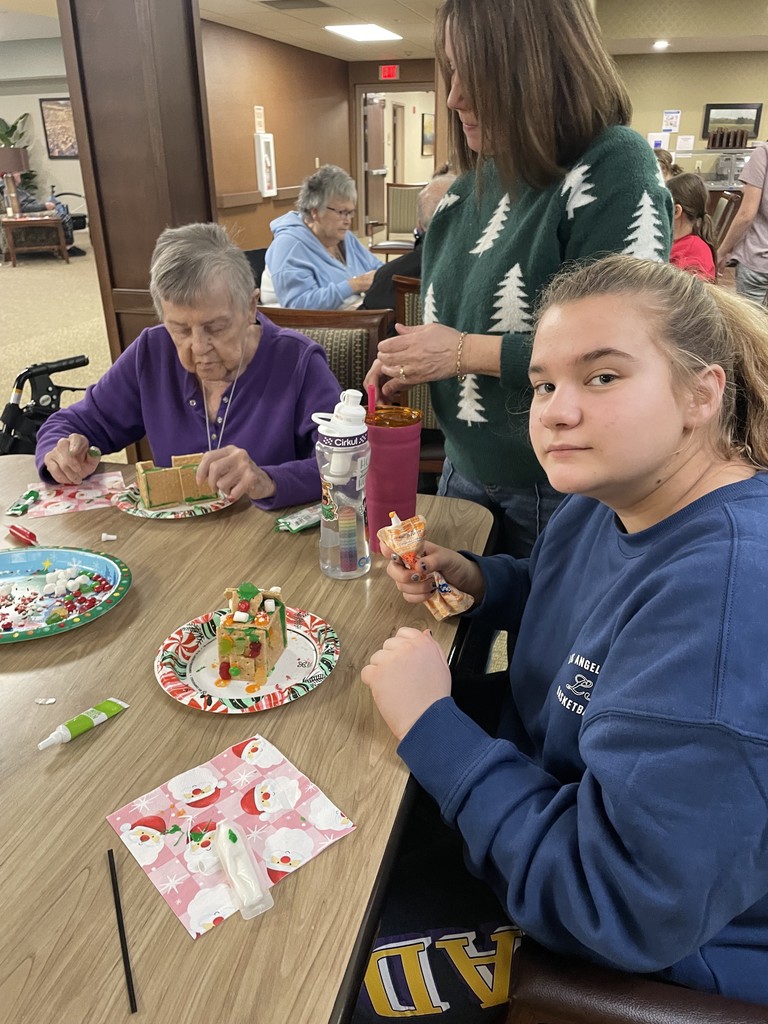Students and Vancrest residents making gingerbread houses