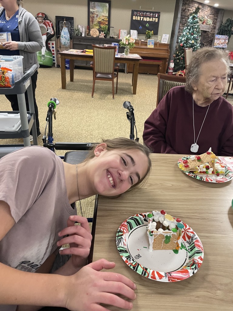 Students and Vancrest residents making gingerbread houses