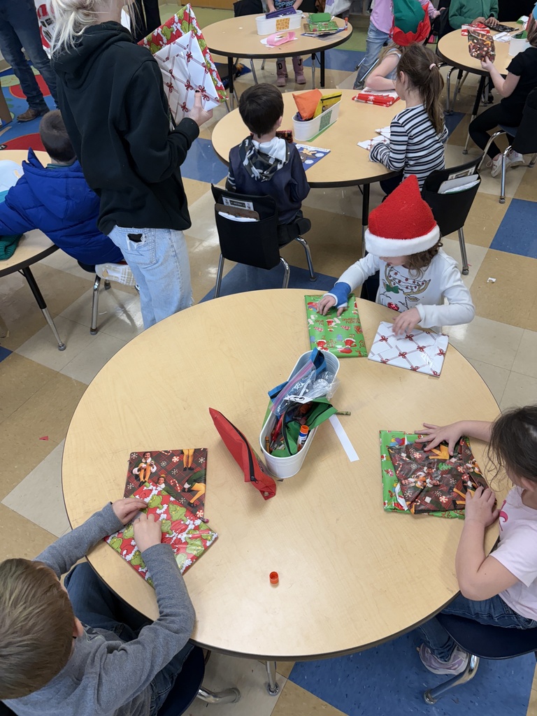 FFA Officers handing our christmas gifts to kindergarteners 