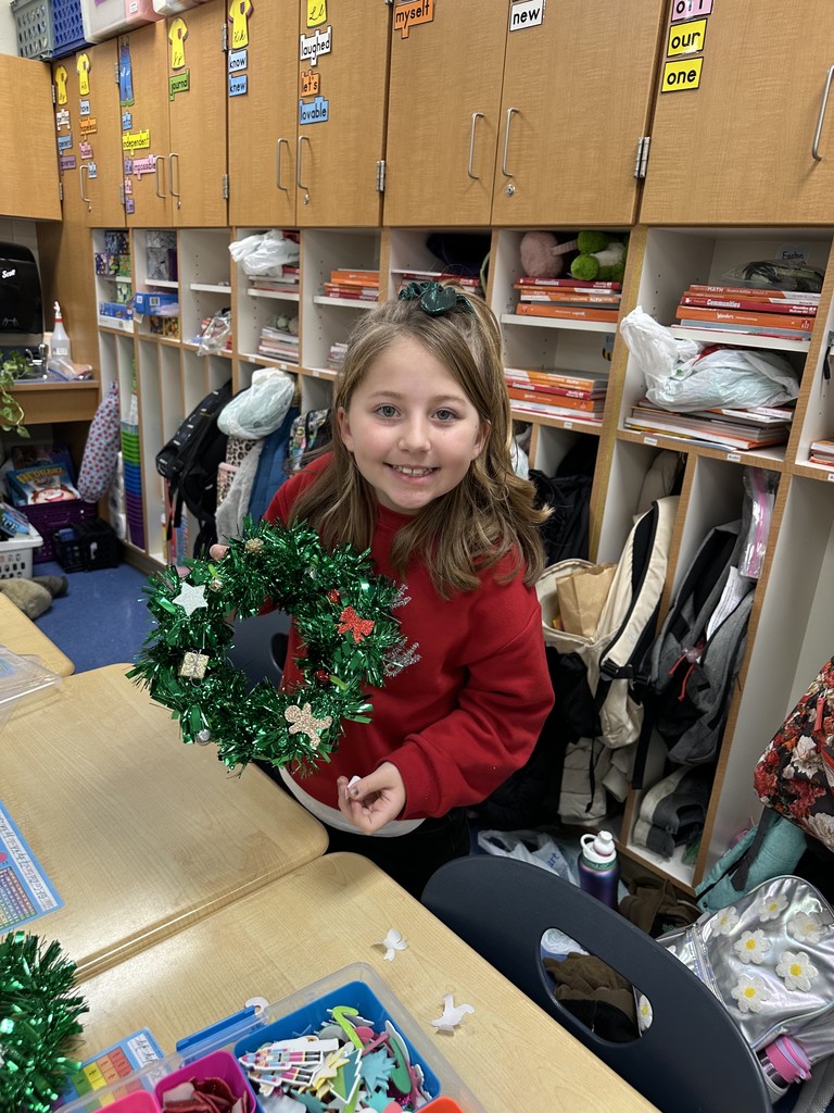 3rd grader making a wreath