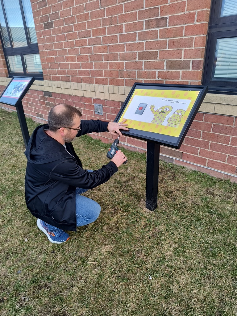 Brock installing a new book in the Storybook Walk