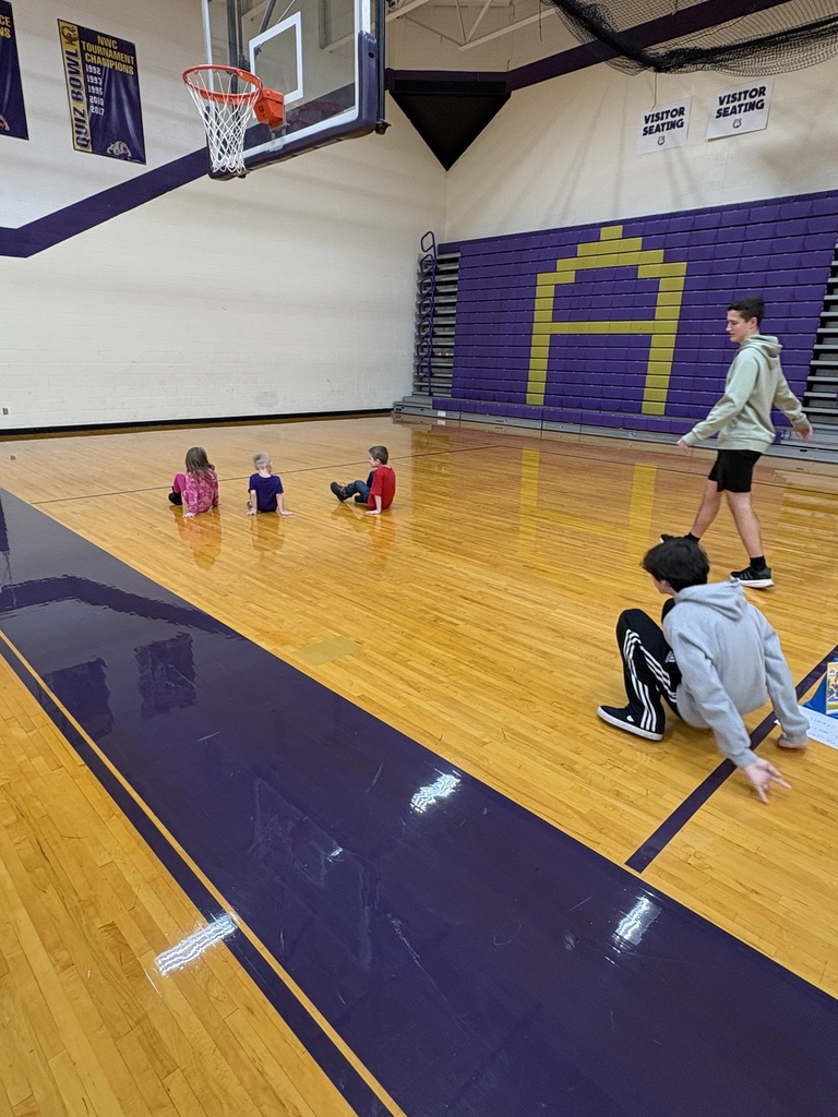 High school students showing preschoolers how to crab walk