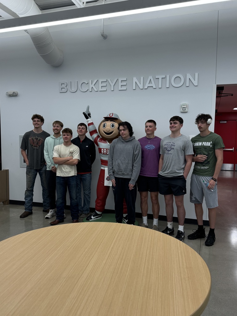 8 high students standing with brutus the buckeye statue
