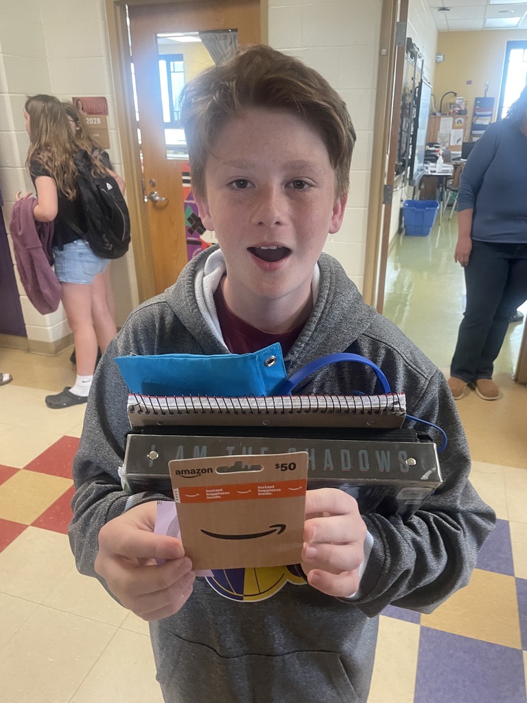 Student with mouth opened holding gift card