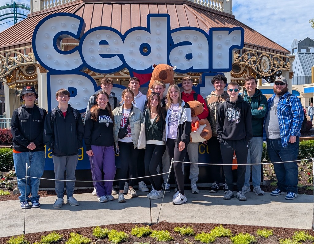 Group of students standing in front of Cedar Point sign