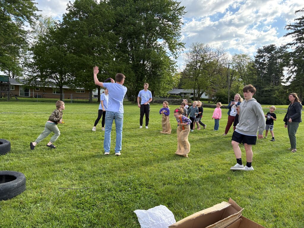 High School Students working with elementary students