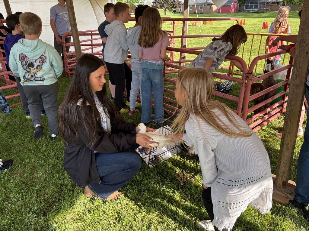 High School Students working with elementary students