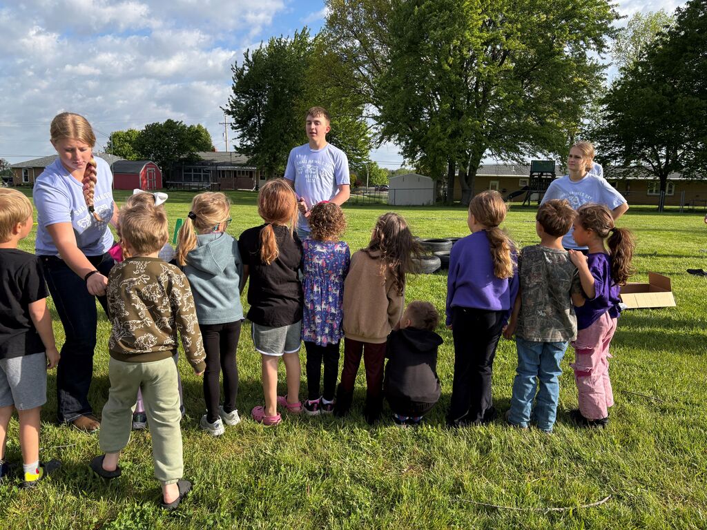 High School Students working with elementary students