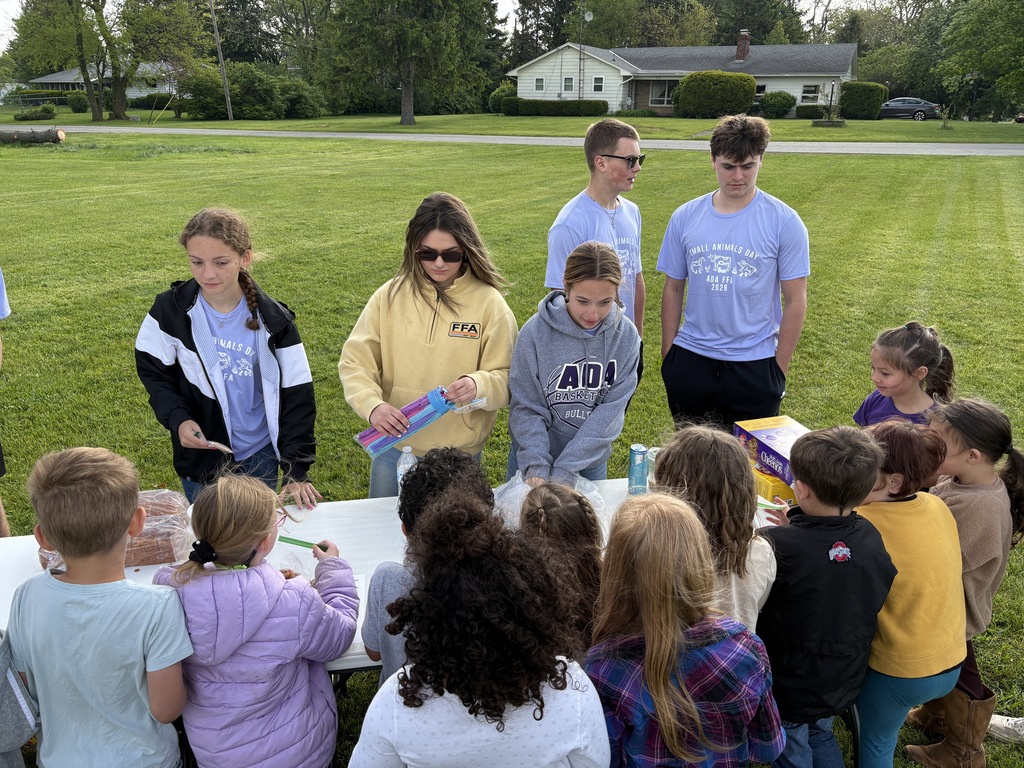 High School Students working with elementary students