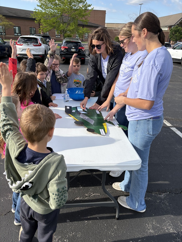 High School Students working with elementary students