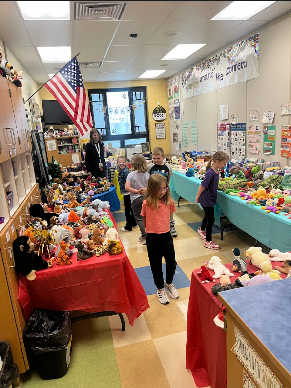 Students searching the table for the perfect stuffed animal