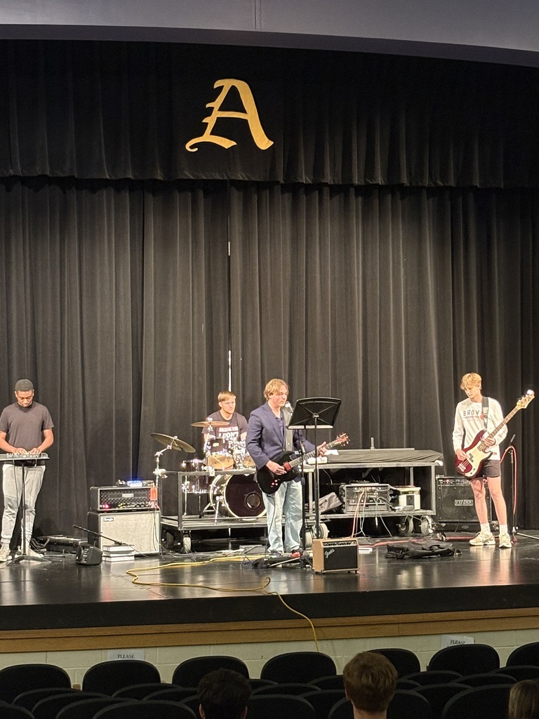 Four band members on a stage 