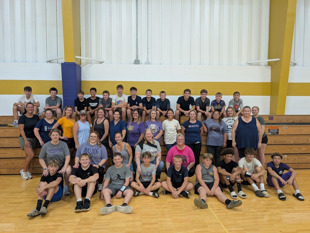 Large group of women and young boys in the gym after a combined practice