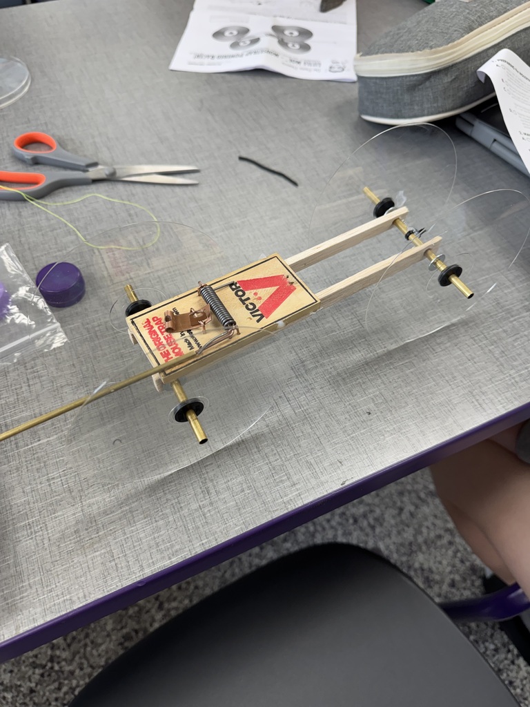 Homemade mousetrap car sitting on a table