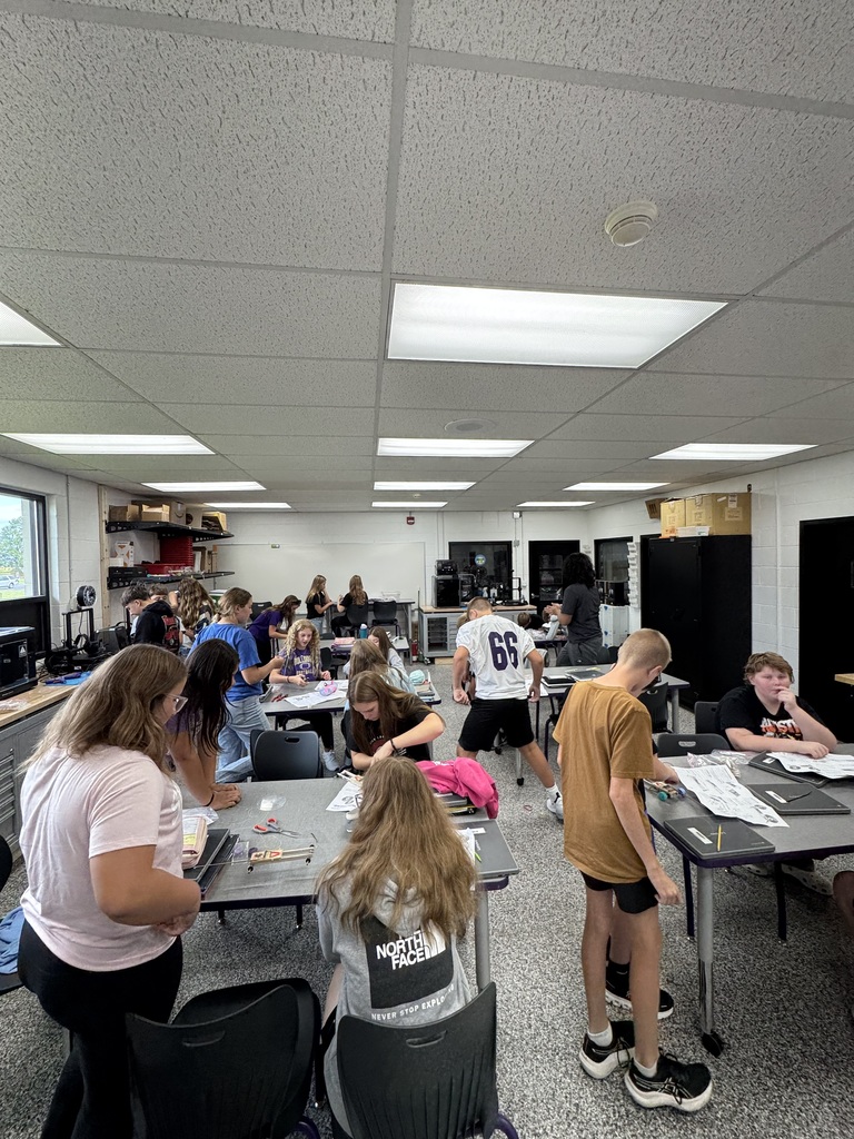 Students sitting at tables working on projects 