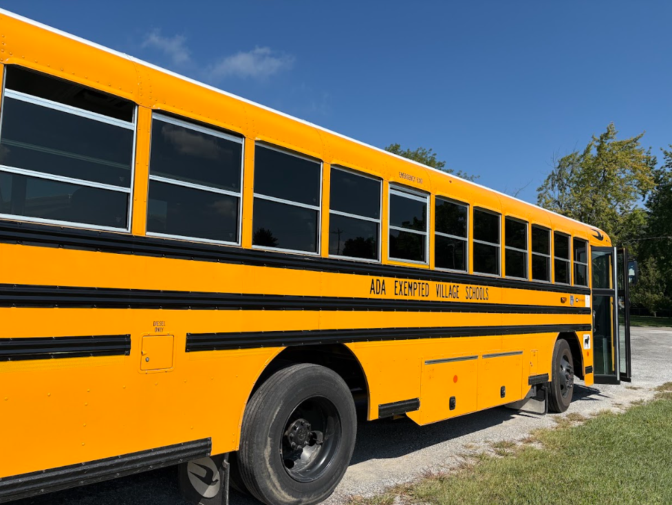 Yellow School bus with doors open and blue skies