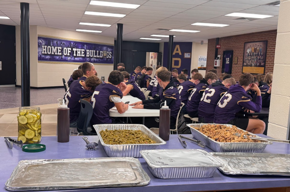 male football players filling white plates with food