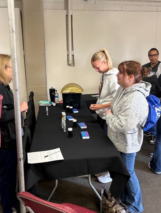 Students walking around a career fair talking with different professionals about potential careers