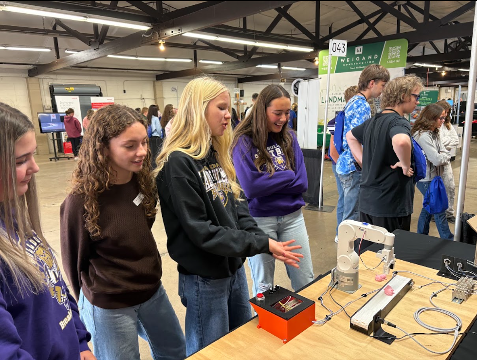Students walking around a career fair talking with different professionals about potential careers