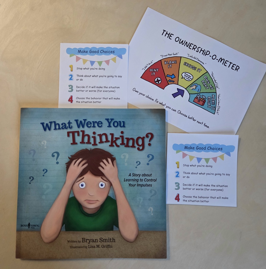Three peices of white paper with color graphics and a book cover with a cartoon boy holding his head in his  hands 