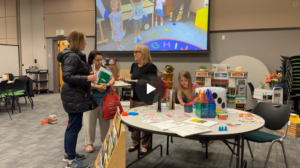 Parents talking to staff in a preschool area
