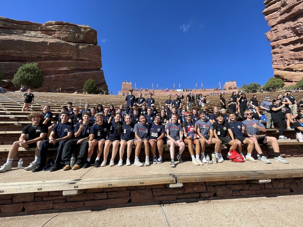 Public safety students sitting on red rocks after climbing in honor of 9/11 first responders