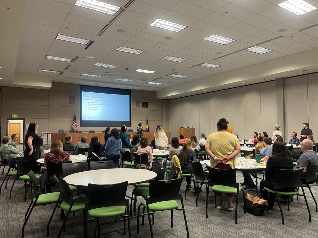 Community members at tables with some standing. 