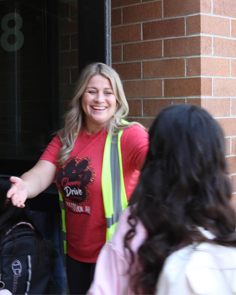 Teacher welcoming student