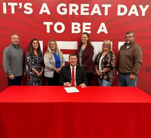 Mr. McClure and Board signing the contract