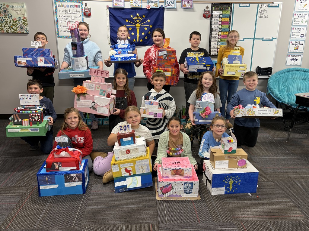 Mrs. Yoder's class showing the birthday cakes they made for Indiana's 209th Birthday