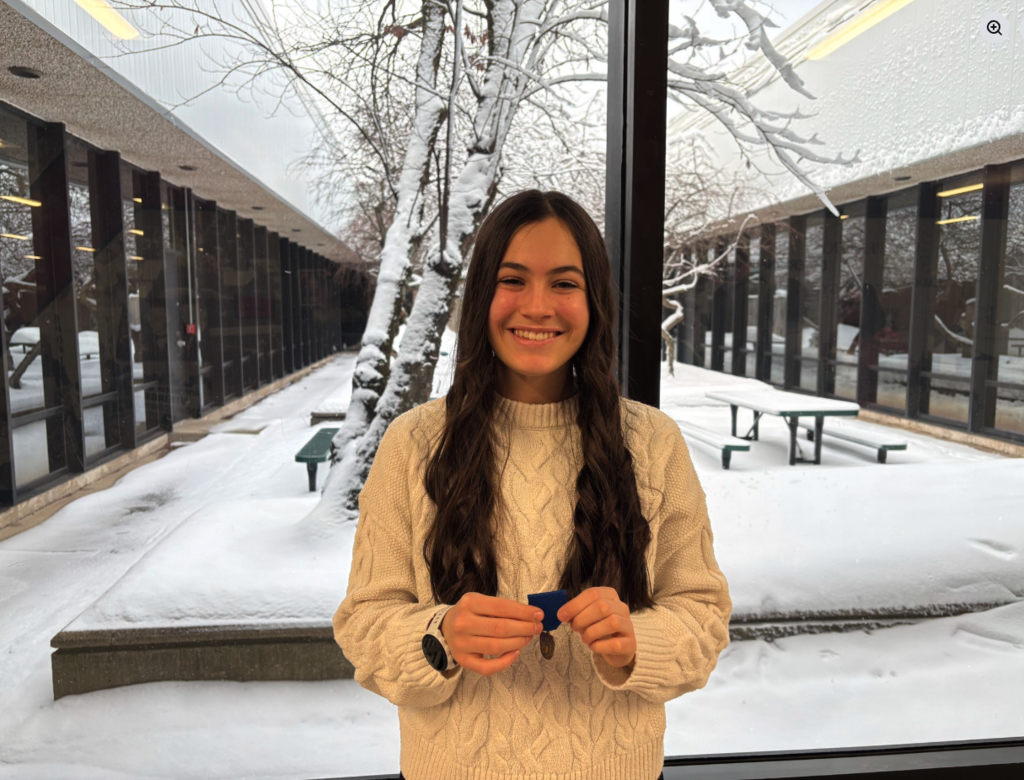 Student  holding ISSMA medal.