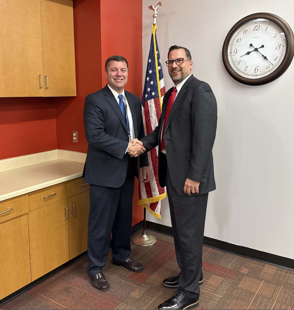 Mr. McClure and Mr. Misch shaking hands