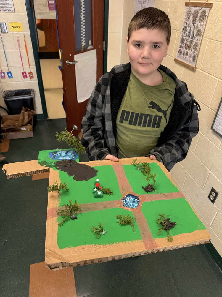 Student holding his landscape project.