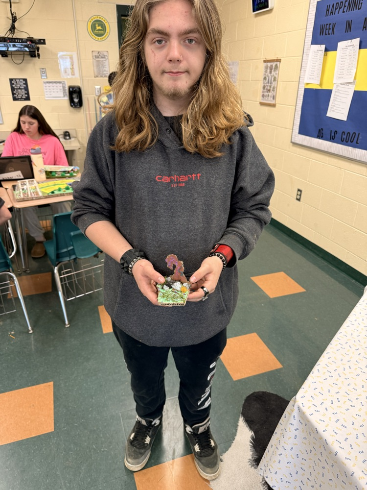 Student holding his landscape project.