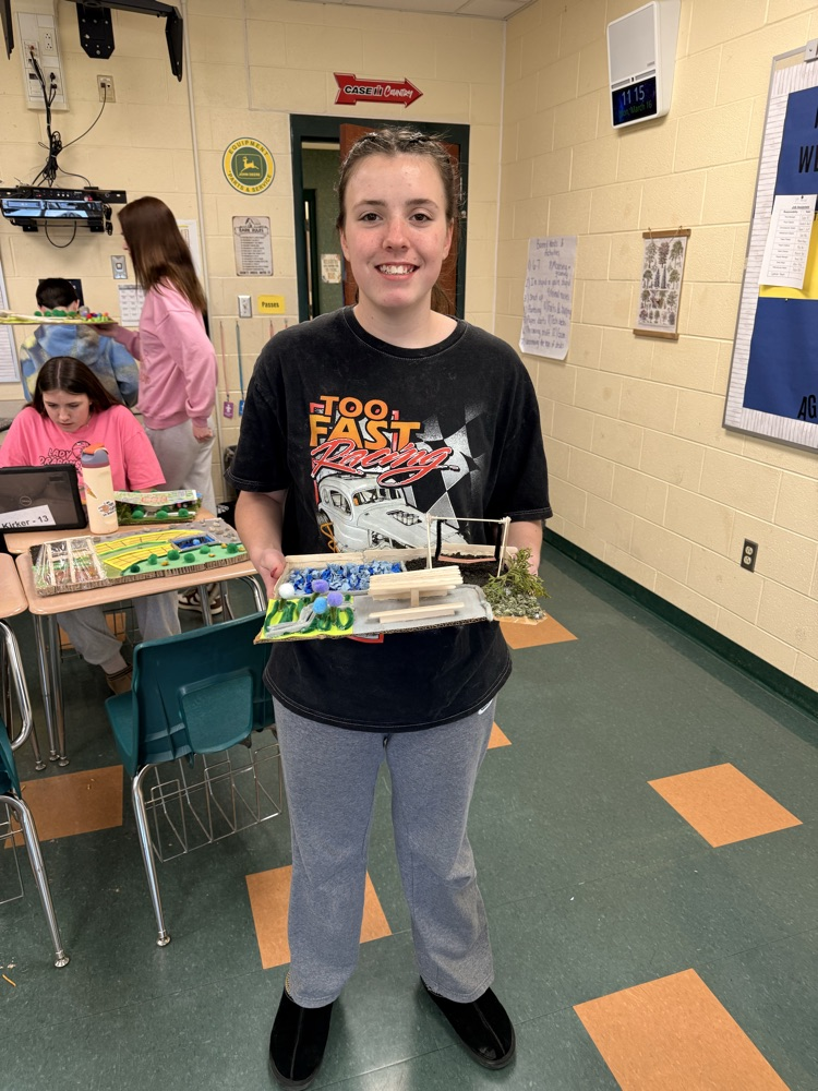 Student holding his landscape project.