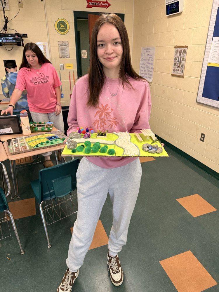 Student holding his landscape project.