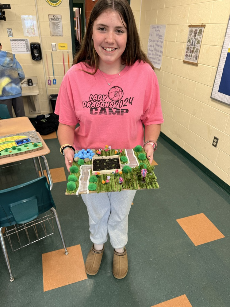 Student holding his landscape project.