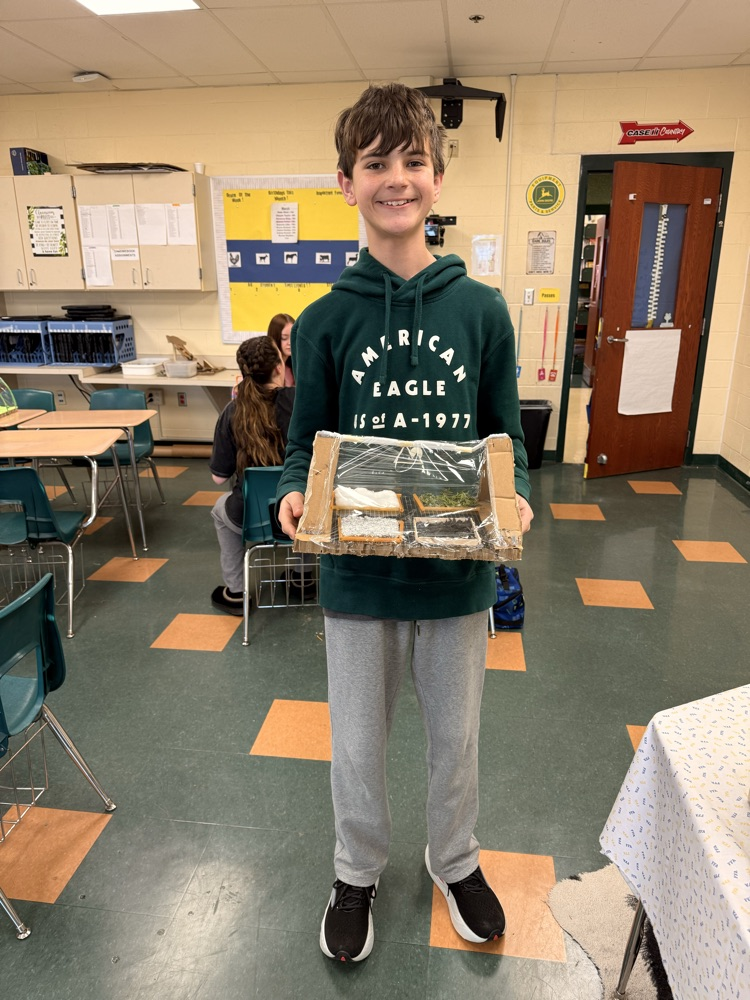 Student holding his landscape project.
